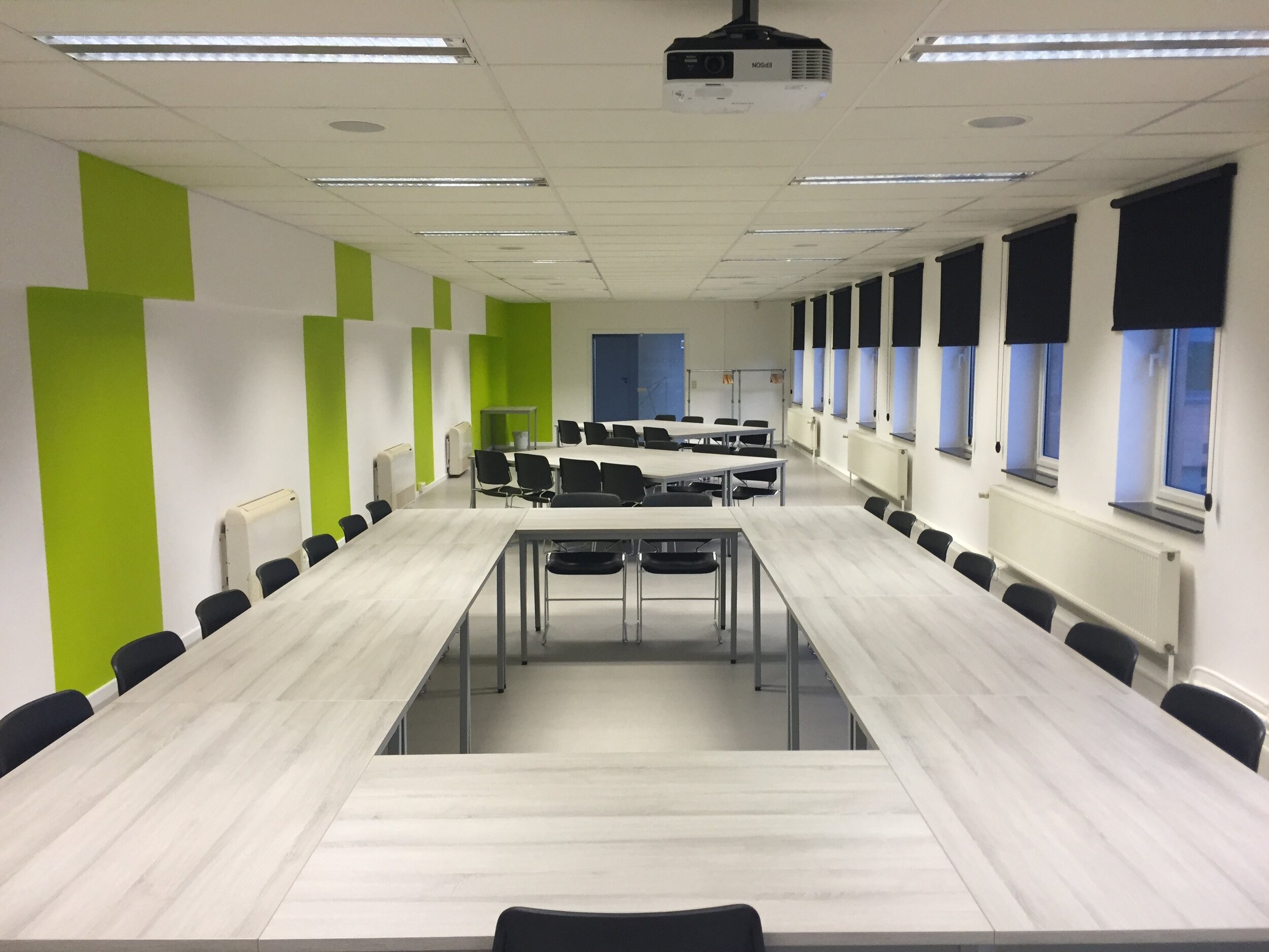 white-wooden-table-and-black-chairs-inside-white-green-159806
